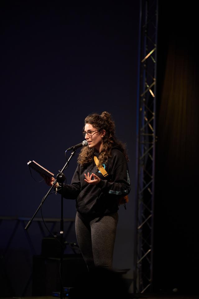 A person presenting her own poetry slam